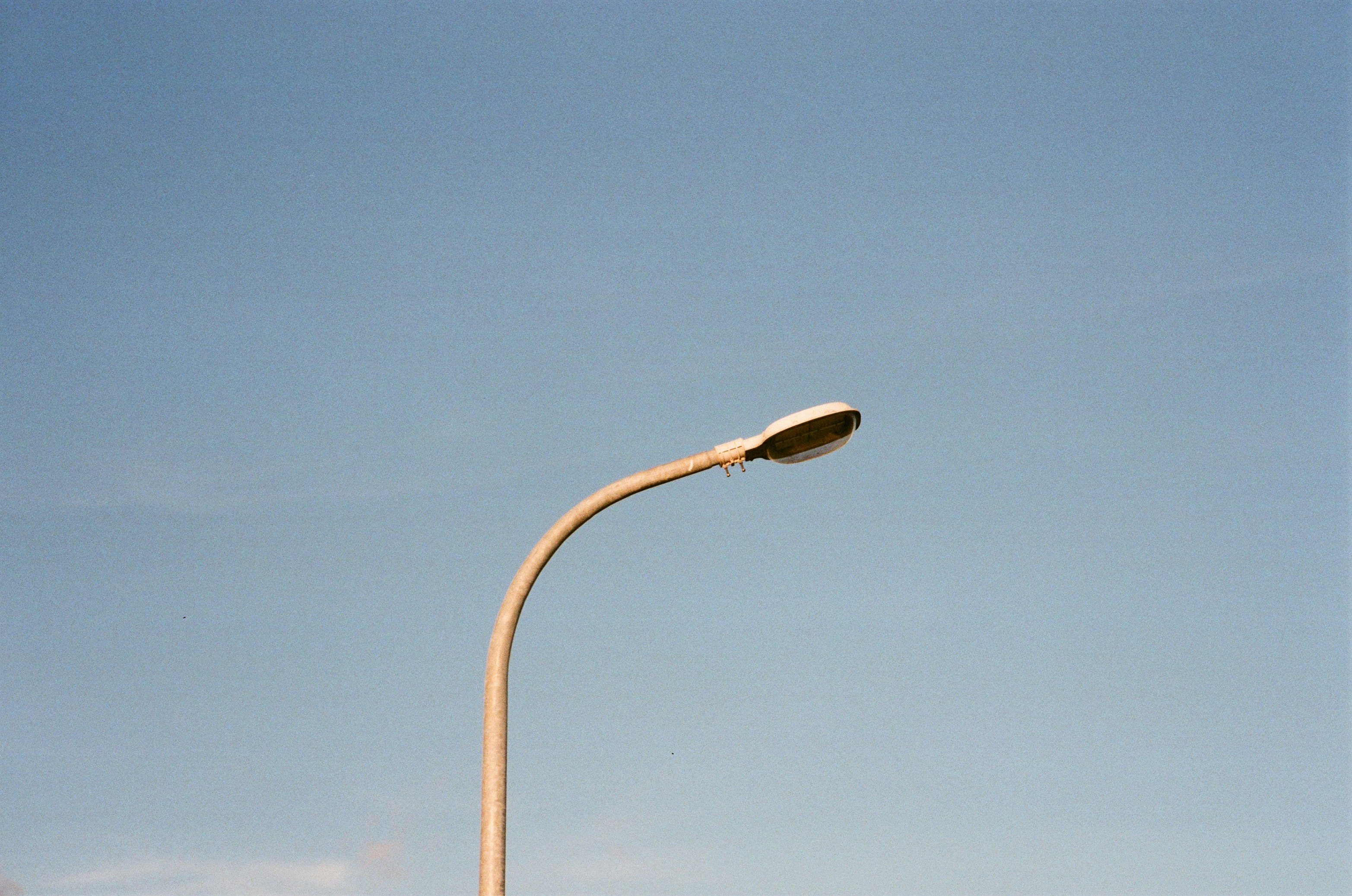 white street light under blue sky during daytime